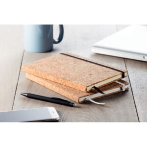 Notebook with logo SUBER A5 Notebook with logo and hard cork cover. Cork is 100% natural material. Case-bound. 192 lined paper (96 sheets). Elastic closure strap, ribbon bookmark and elastic pen holder. Due to its structural nature and surface porosity the final print result per item may have deviations. Depending on the surface we can use embroidery, engraving, 360° imprint or screen print.