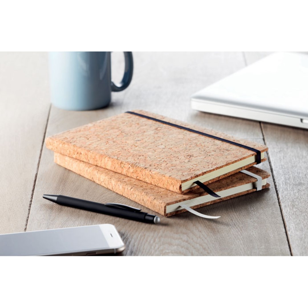 Notebook with logo SUBER A5 Notebook with logo and hard cork cover. Cork is 100% natural material. Case-bound. 192 lined paper (96 sheets). Elastic closure strap, ribbon bookmark and elastic pen holder. Due to its structural nature and surface porosity the final print result per item may have deviations. Depending on the surface we can use embroidery, engraving, 360° imprint or screen print.