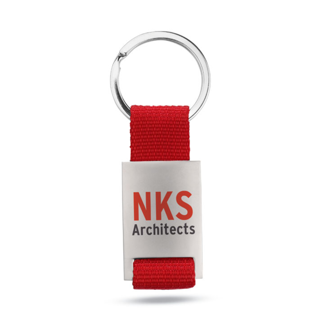 Gadget with logo Key ring TECH Metal rectangular key ring with logo with coloured polyester webbing. Individually packed in a carton gift box. Available color: Red, Blue, Black Dimensions: 9X3,5X0,8 CM Width: 3.5 cm Length: 9 cm Height: 0.8 cm Volume: 0.11 cdm3 Gross Weight: 0.034 kg Net Weight: 0.026 kg Magnus Business Gifts is your partner for merchandising, gadgets or unique business gifts since 1967. Certified with Ecovadis gold!