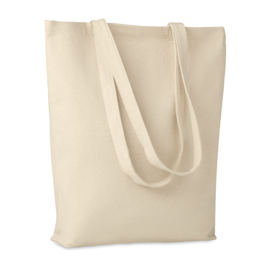 Gadget with logo Totebag RASSA Canvas shopping bag with logo with long handles and with bottom gusset. An ideal bag for your daily grocery shopping. The long handles make it easy to carry it by either holding it or hanging it over your shoulder. This canvas tote has a base gusset so you can carry more items than with a regular shaped bag. 270 gr/m². Produced under a certified standard for the use of harmful substances in textile. Available color: Beige Dimensions: 38X9X42 CM Width: 9 cm Length: 38 cm Height: 42 cm Volume: 0.722 cdm3 Gross Weight: 0.164 kg Net Weight: 0.149 kg Magnus Business Gifts is your partner for merchandising, gadgets or unique business gifts since 1967. Certified with Ecovadis gold!