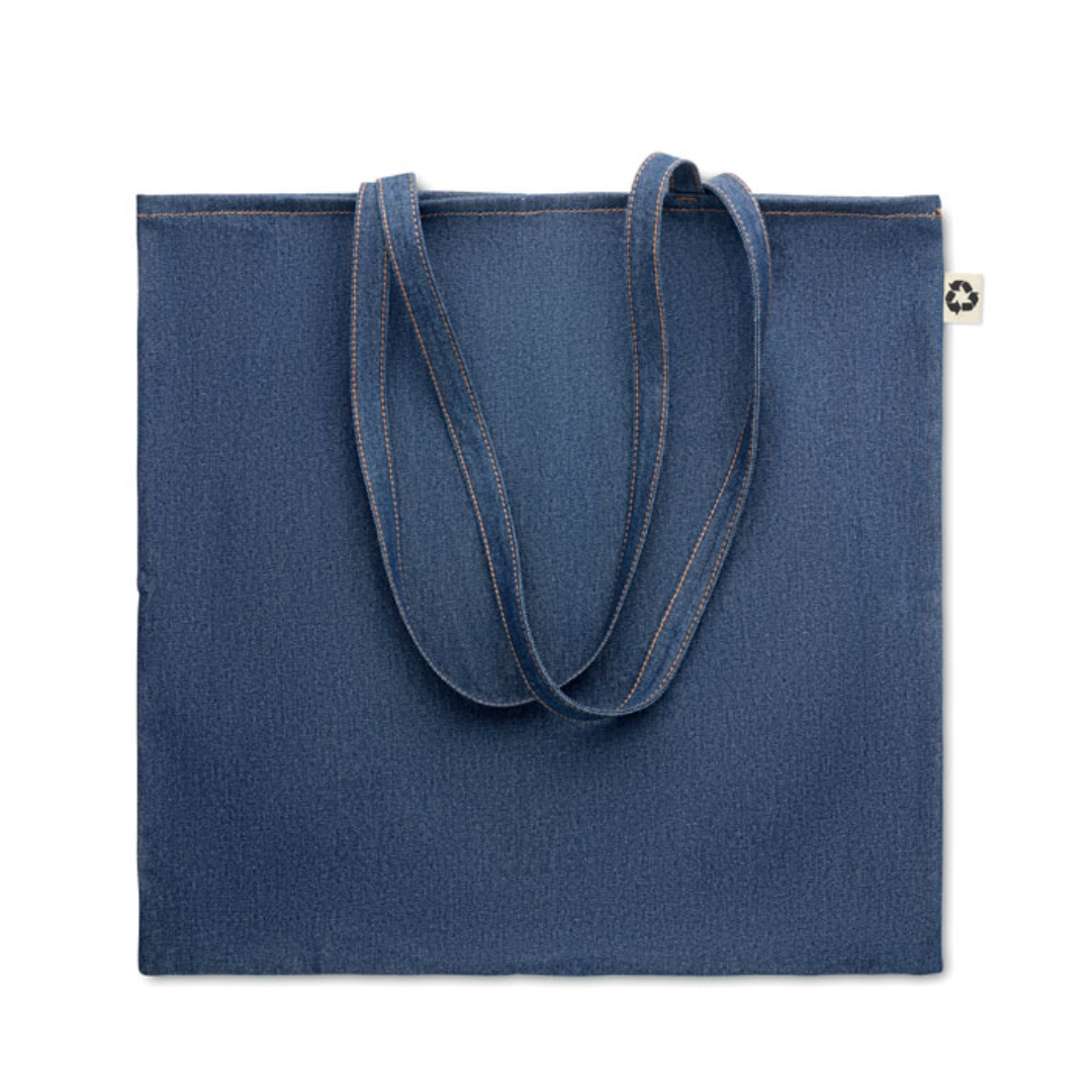 Gadget with logo Totebag STYLE TOTE 50% Recycled cotton dye denim and 50% cotton shopping bag with logo with long handles. 250 gr/m². This tote is perfect for daily grocery shopping or carrying other items with you. Carry the bag with your hands or hang it over your shoulder to keep your hands free. The denim look makes this stylish bag stand out. Available color: Blue Dimensions: 42X40CM Width: 40 cm Length: 42 cm Volume: 0.6 cdm3 Gross Weight: 0.15 kg Net Weight: 0.137 kg Magnus Business Gifts is your partner for merchandising, gadgets or unique business gifts since 1967. Certified with Ecovadis gold!