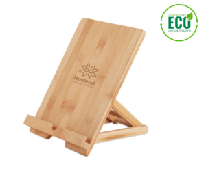 Gadget with logo tablet stand TUANUI Gadget with logo, foldable tablet or smartphone stand in bamboo. The opening in the bottom of the stand allows for charging or earphone cables to pass through. Bamboo is a natural product, there may be slight variations in color and size per item, which can affect the final decoration outcome. Available color: Wood Dimensions: 22,3X16,8X4,2CM Width: 16.8 cm Length: 22.3 cm Height: 4.2 cm Volume: 2.133 cdm3 Gross Weight: 0.383 kg Net Weight: 0.296 kg Depending on the surface we can use embroidery, engraving, 360° imprint or screen print.