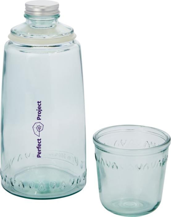 Gadget with logo Glass bottle Vient Gadget with logo, Glass bottle 2-piece recycled glass set featuring one 1000 ml carafe with aluminium lid. Made from 1 glass bottle. 220 ml cup. Recycled glass is manufactured using less energy, raw material, and additives, than what is required for making traditional glass. Available color: Transparent Height: 26 cm, Diameter: 10 cm Weight: 530gr Depending on the surface we can use embroidery, engraving, 360° imprint or screen print.