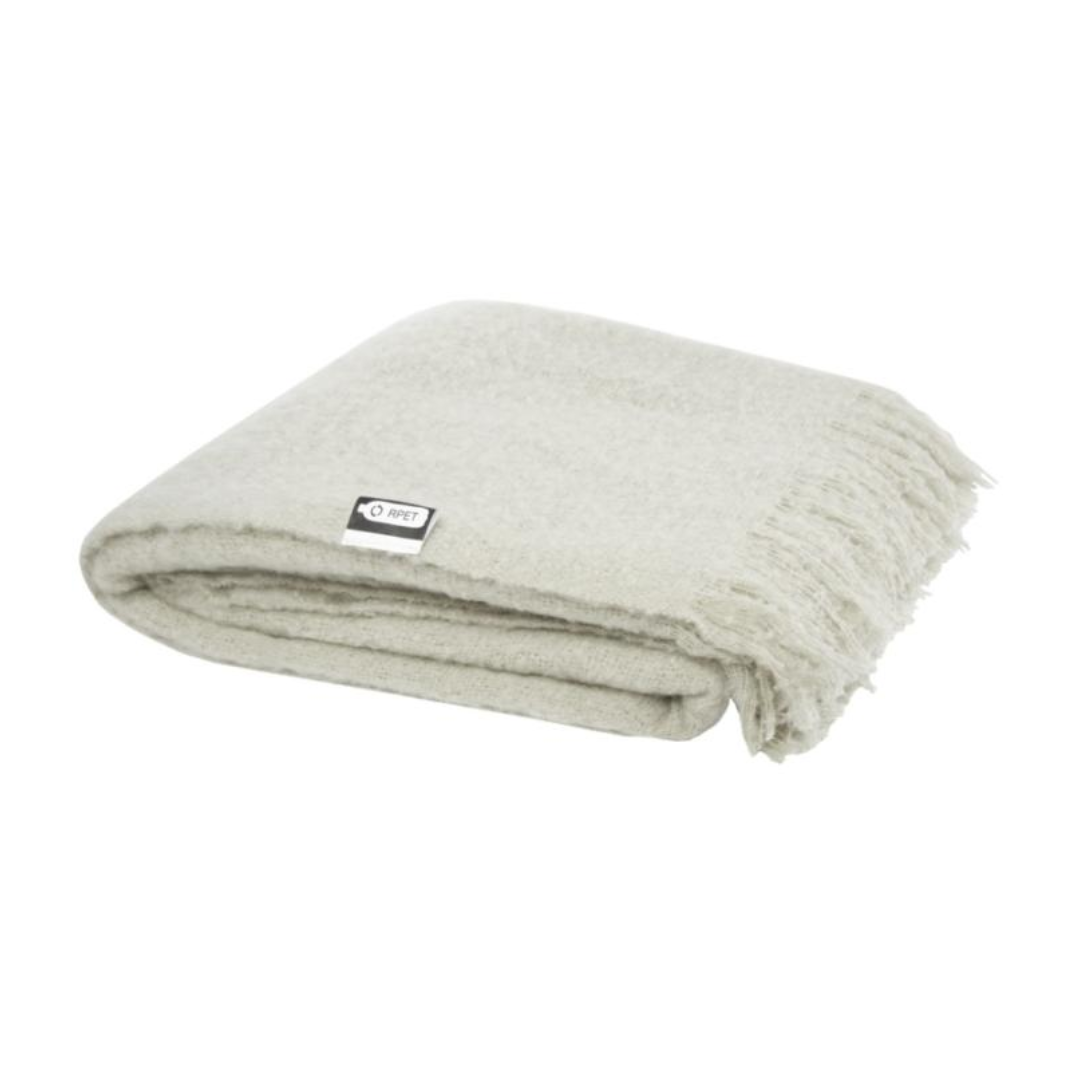 Gadget with logo PLAID blanket Ivy Gadget with logo Ultra-soft RPET mohair plaid, wrapped with a 190T RPET ribbon. Packed in a recycled poly bag. Fringes length: 10 cm on each side. Ribbon size: 72 cm x 4 cm. 100% Recycled Polyester, 215 g/m2, 190T of 100% Recycled Polyester. Available colors: Beige, Light Grey Depending on the surface we can use embroidery, engraving, 360° imprint or screen print.