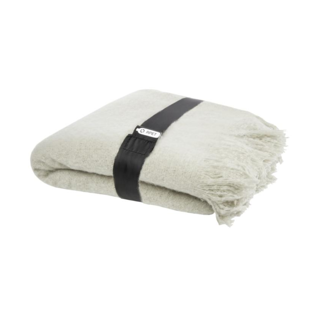 Gadget with logo PLAID blanket Ivy Gadget with logo Ultra-soft RPET mohair plaid, wrapped with a 190T RPET ribbon. Packed in a recycled poly bag. Fringes length: 10 cm on each side. Ribbon size: 72 cm x 4 cm. 100% Recycled Polyester, 215 g/m2, 190T of 100% Recycled Polyester. Available colors: Beige, Light Grey Depending on the surface we can use embroidery, engraving, 360° imprint or screen print.