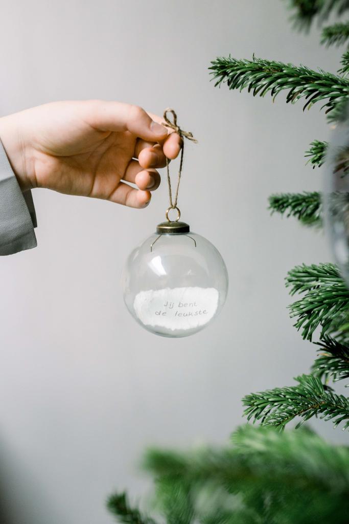 A special Christmas ball with logo message inside can be a wonderful and personalized gift or decoration for the holiday season. This unique ball combines the beauty of traditional ornaments with the element of surprise and sentimentality. This Christmas ball is made of clear translucent glass allowing the paper message inside to be visible. MOQ 250pcs. The paper message is an integral part of this special ornament. You can customize the message with a heartfelt note, a favorite quote, a special memory, or a wish for the recipient. Write or print the message on a durable, lightweight paper that can easily be rolled or folded to fit inside the ball. The beauty of this Christmas ball lies not only in its visual appeal but also in the heartfelt message contained within. It's a delightful way to show someone you care and to add a touch of personalized magic to their holiday celebrations. Magnus Business Gifts is your partner for merchandising, gadgets or unique business gifts since 1967. Certified with Ecovadis gold!