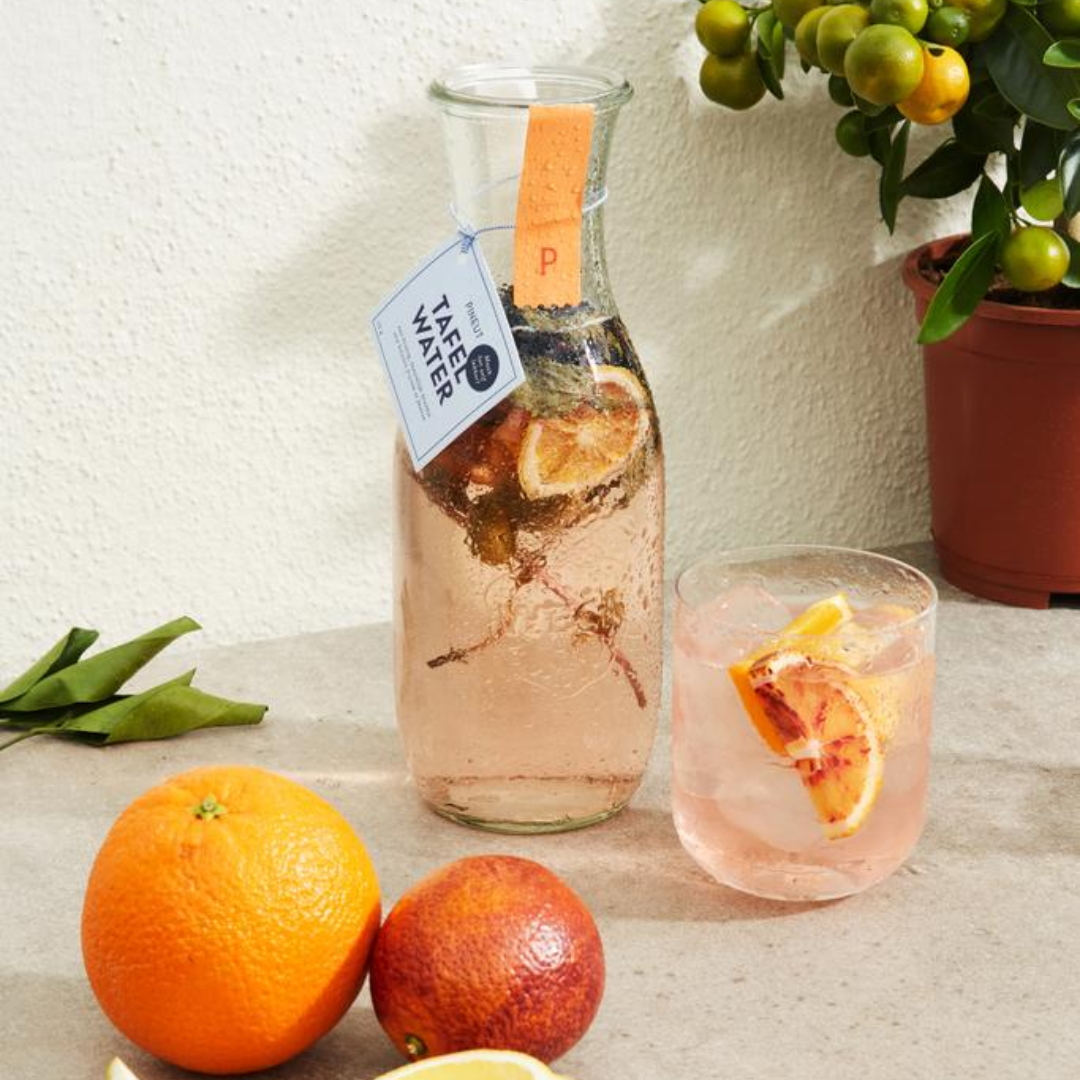 Gadget apéro Carafe table water with dried fruit Our refreshing table waters come in a beautiful carafe with glass lid and clamps. With this you not only give a delicious, but also lasting gift. Inside the bottle you can find a refreshing combination of lemon slices, orange slices, blueberries and mint! Different flavors possible - Dimensions: 6 x 6 x 25 CM - Package: EAN Sticker Fill the bottle with water. Leave for at least 30 minutes and serve immediately. Feel free to refill with water a few times during the day. The fruit and leaves give off a lot of flavour. Magnus Business Gifts is your partner for merchandising, gadgets or unique business gifts since 1967. Certified with Ecovadis gold!
