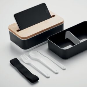 2 Layer Lunchbox with logo in PP WINT Recycled PP two-tier lunch box with removable divider. Including 3 cutlery utensils with attachable polyester band with bamboo lid. The lid has a phone stand functionality. Capacity: 400 ml (2x). Bamboo is a natural product, there may be slight variations in colour and size per item, which can affect the final decoration outcome. Magnus Business Gifts is your partner for merchandising, gadgets or unique business gifts since 1967. Certified with Ecovadis gold!