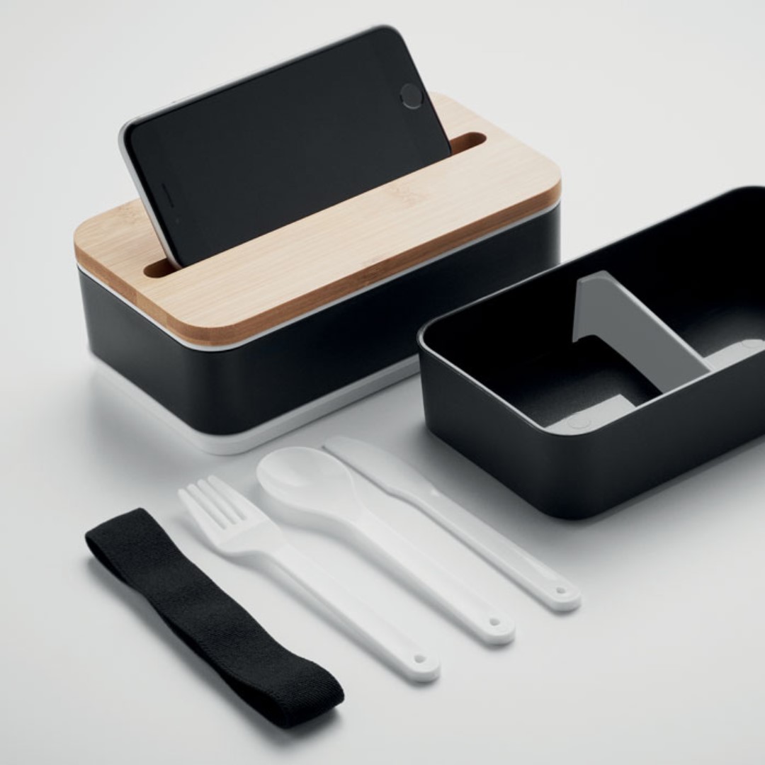 2 Layer Lunchbox with logo in PP WINT Recycled PP two-tier lunch box with removable divider. Including 3 cutlery utensils with attachable polyester band with bamboo lid. The lid has a phone stand functionality. Capacity: 400 ml (2x). Bamboo is a natural product, there may be slight variations in colour and size per item, which can affect the final decoration outcome. Magnus Business Gifts is your partner for merchandising, gadgets or unique business gifts since 1967. Certified with Ecovadis gold!
