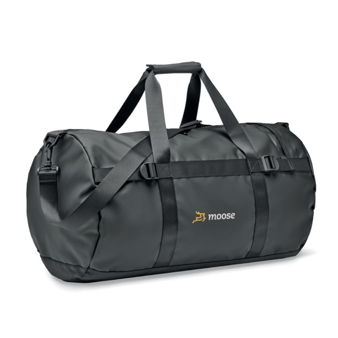 Bag with logo Jaya Duffle Duffle bag, sports or travel bag in 50C tarpaulin with zippered side compartment and zippered inner pocket. With comfort grip handle and padded base. Dimensions: 49X28X28CMWidth: 28 cm Length: 49 cm Height: 28 cm Volume: 7.5 cdm3Gross Weight: 0.75 kg Net Weight: 0.65 kg Available colour black. Magnus Business Gifts is your partner for merchandising, gadgets or unique business gifts since 1967. Certified with Ecovadis gold!