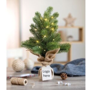 Mini Christmas tree with logo AVETO Mini artificial (PE) Christmas tree with 20 LED warm yellow string lights on a jute base. Comes with a wooden gift tag. 2 AA batteries excluded. Magnus Business Gifts is your partner for merchandising, gadgets or unique business gifts since 1967. Certified with Ecovadis gold!