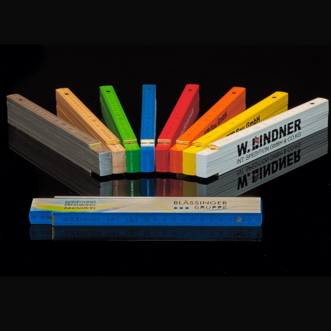 Wooden Folding Ruler with logo Multi-Colors Beech wood folding rule in good quality with black scaling. Thanks to inlaid metal spring joints the folds are close to each other. 8 standard colors from 100pcs. MATERIAL Beechwood MEASURING ACCURACY CE + EEC-class III LENGTH 2m VERSION Good quality COLOUR(S): White - HKS 4 - HKS 8 - Cola - HKS 44 - HKS 64 - Silver - Nature SCALING cm RULE THICKNESS 3mm WEIGHT 105g FINISHING OPTIONS Pad printing digital imprint ADVERTISING SPACE 160mm x 25mm all over DIMENSIONS 248mm x 33mm x 16mm Magnus Business Gifts is your partner for merchandising, gadgets or unique business gifts since 1967. Certified with Ecovadis gold!