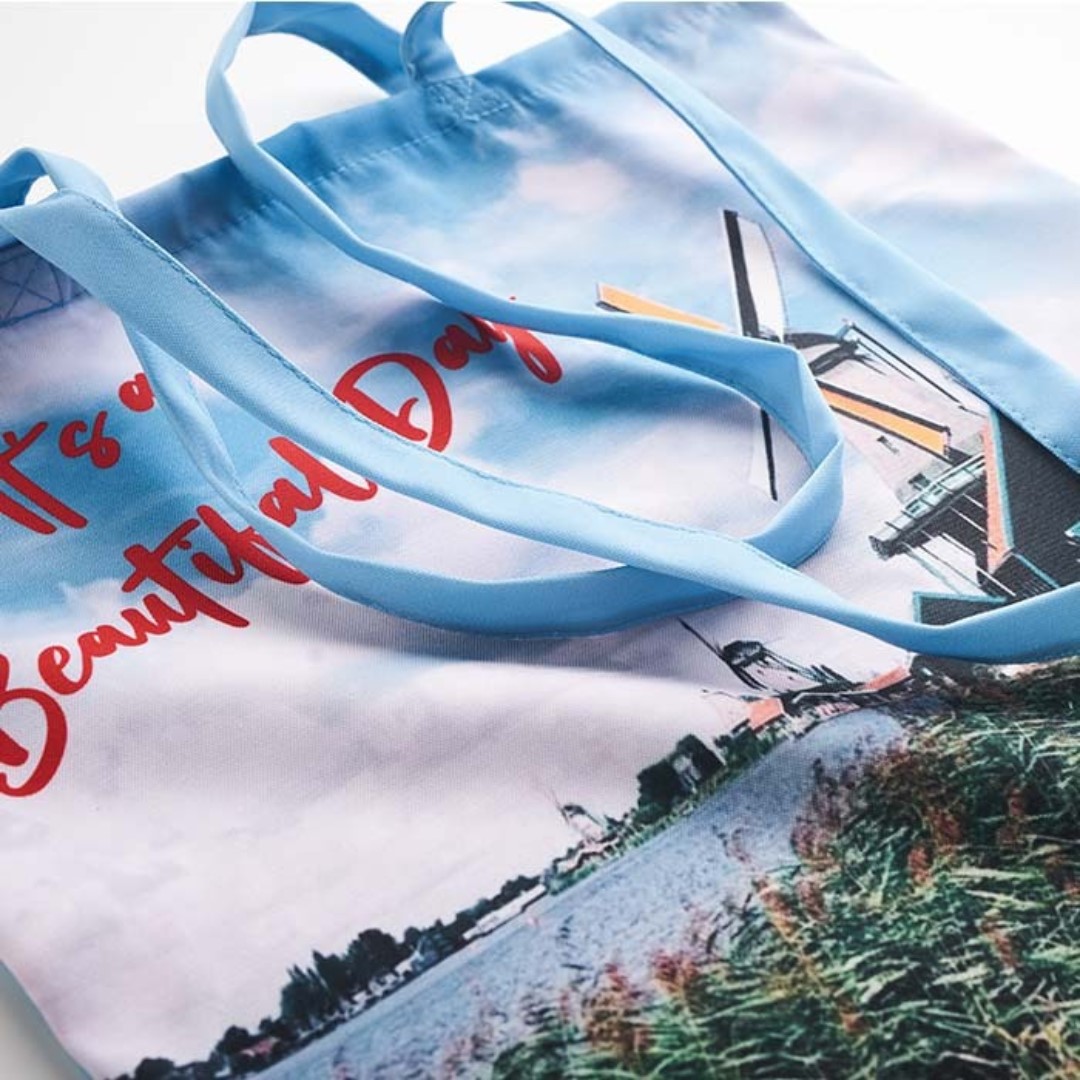 Custom Made Sublimation Totebags Introducing our Sublimation Tote Bags, crafted with precision and style to elevate your carrying experience. Available in either polyester or RPET (Recycled PET) material, these tote bags are designed for sustainability without compromising on vibrant aesthetics. The magic of full-color printing comes to life with our all-over sublimation technique, allowing your unique designs, patterns, or branding to grace both sides of the bag and even extend seamlessly to the handles. The result is a visually stunning, high-quality tote that stands out from the crowd. Dimensions: 38x42cm. Long handles 70x2cm. REQUEST A FREE QUOTE The easiest way to kick off your design process is to request a quote. In your request, you can share your idea, your deadline, and send us images of your character. MOQ required. Magnus Business Gifts is your partner for merchandising, gadgets or unique business gifts since 1967. Certified with Ecovadis gold!